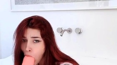 Beautiful redhead uses toy to masturbate