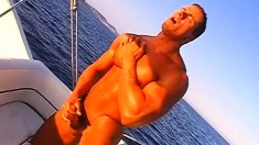 Hot stud with a muscled body pleases his long cock out on a boat